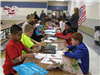 Children in cafeteria working on crafts