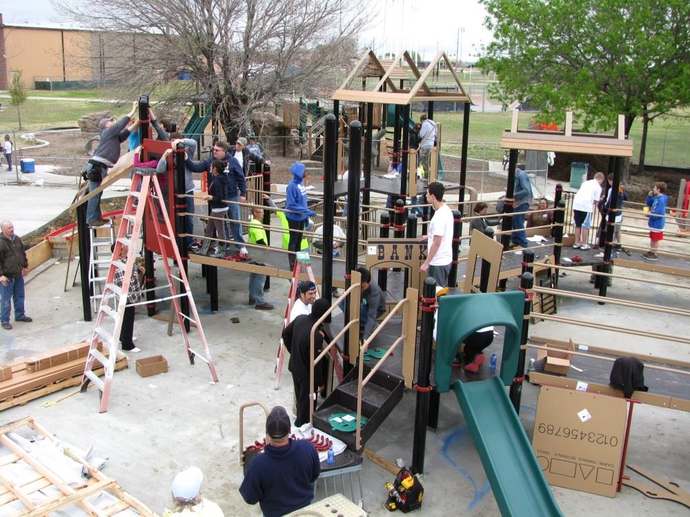 Community building effort with lots of play equipment and tools