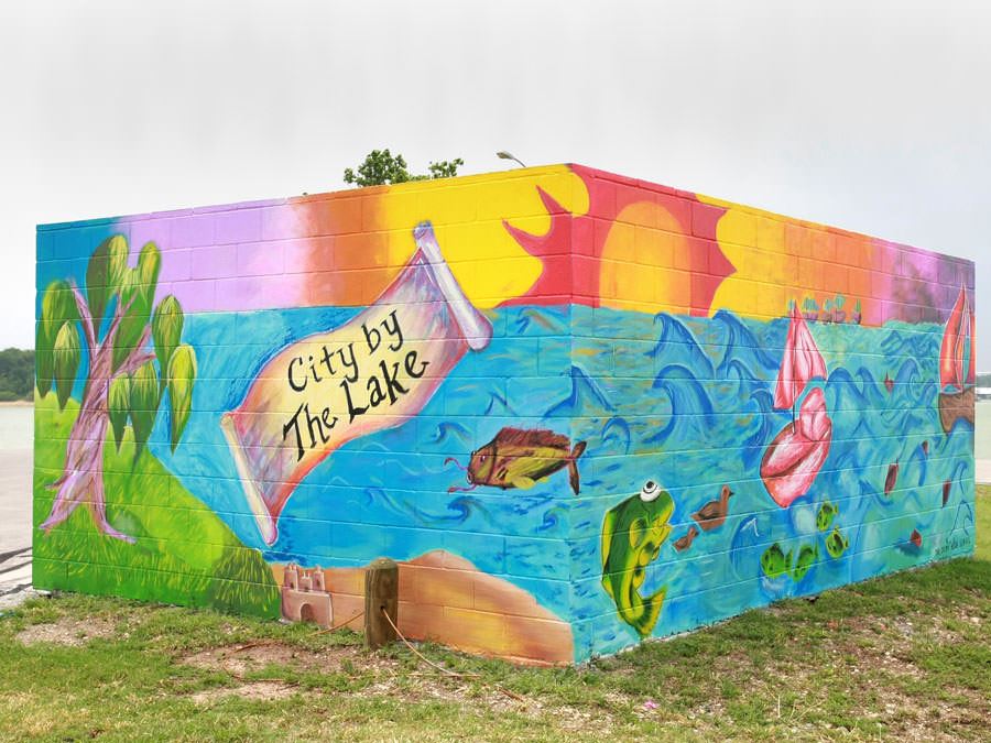 Murals on dumpster enclosures at Stewart Creek Park